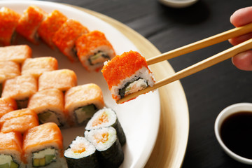 Eating sushi rolls at japanese food restaurant