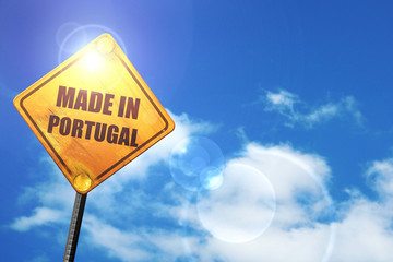 Yellow road sign with a blue sky and white clouds: Made in portu