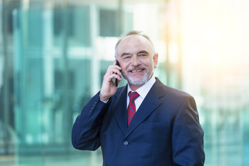 senior business man using on mobile phone