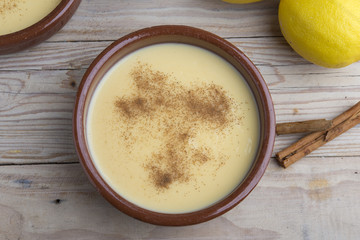 Traditional creme brulee on ceramic dish on wooden table