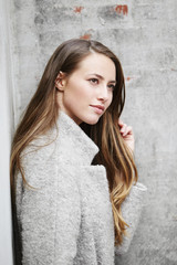 Beautiful woman in gray looking away