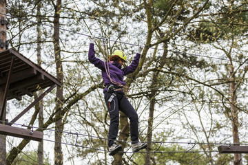 Woman on cables in an adventure park on a difficult course