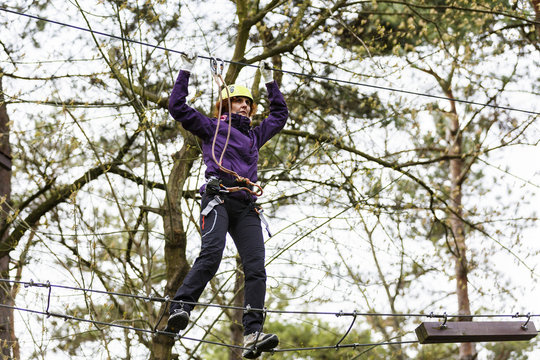 Woman on cables in an adventure park on a difficult course
