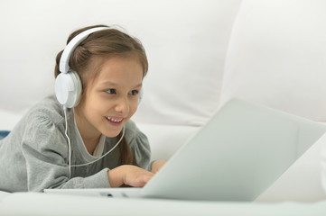 smiling little girl with laptop computer