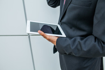 Businessman using tablet pc. Close up.