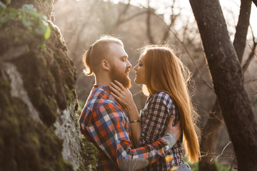 Loving couple, sunset,red-haired people, mountains,a man with a beard