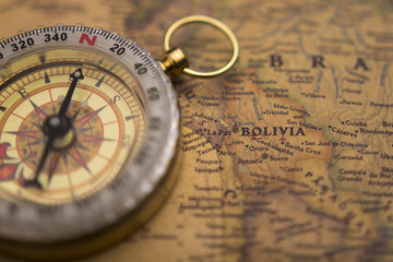 Fototapeta na wymiar Old compass on vintage map selective focus on Bolivia