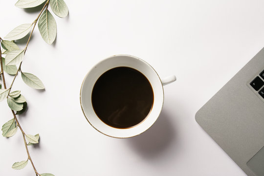 Foreground seen from above of a computer and a cup of tea