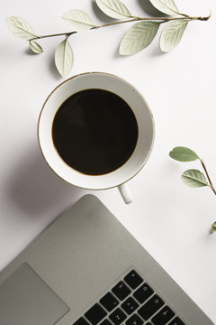 Foreground seen from above of a computer and a cup of tea