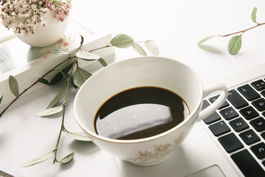 Foreground seen from above of a computer and a cup of tea