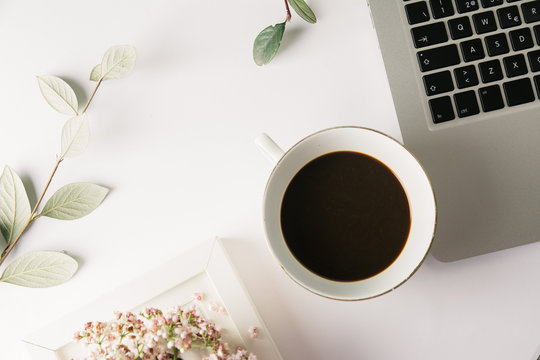 Foreground seen from above of a computer and a cup of tea