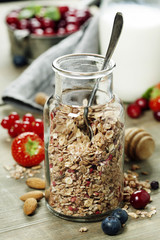 Close up of jar with granola or muesli on table