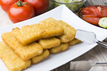 Meat croquettes served with fresh vegetables.