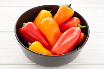 Colorful mini paprika on a white wooden table