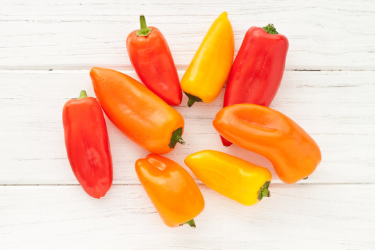 Colorful mini paprika on a white wooden table