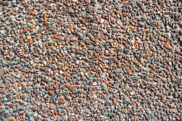Crushed gravel in cement wall plastered texture