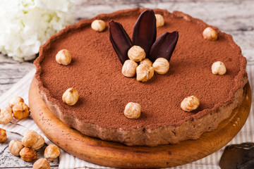 Obraz na płótnie Canvas chocolate tart with hazelnuts