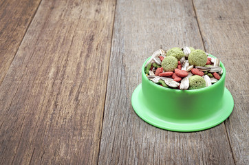 Selective focus, Hamster food in green tray on wooden background, With place for your text 