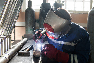 Closeup of man wearing mask welding in a workshop