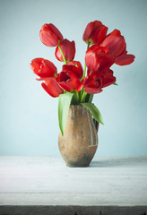 tulips in a vase on white background isolated