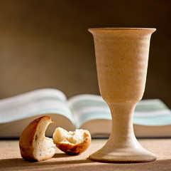 stilllife with chalice of wine, bible and bread