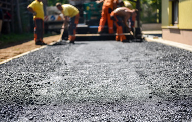 Team of Workers making and constructing asphalt road constructio - obrazy, fototapety, plakaty