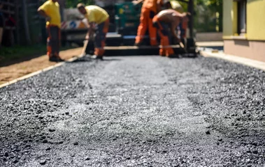 Fotobehang Team of Workers making and constructing asphalt road constructio © _jure