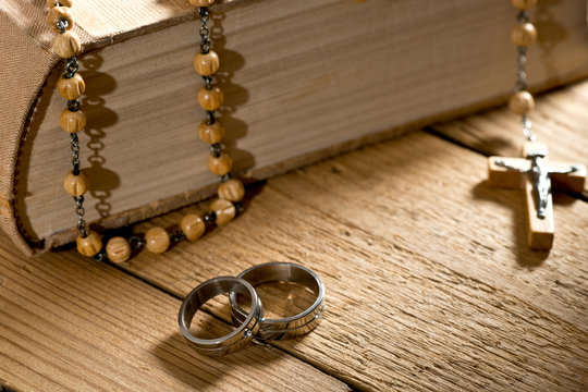 weddings rings, bible and prayer beads
