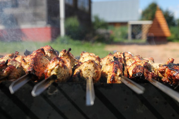 Grilling marinated shashlik on a grill