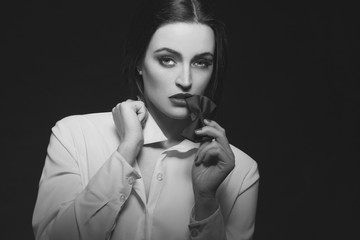 Obraz premium Sensual woman bite tux at night black and white