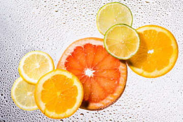 Tropical fruits with water drops