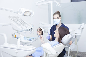 Beautiful woman patient having dental treatment at dentist's office. Woman visiting her dentist