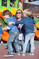 Kids hugging their mother