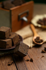 Brown sugar chunks in wooden boxes and plates