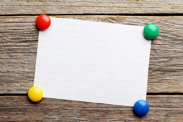 Sheet of paper on grey wooden background