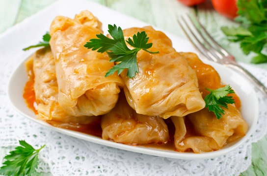 Stuffed cabbage rolls with rice and meat on a white plate