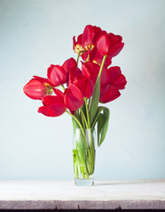Still life with red tulips and pear