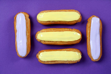 Eclairs with glaze on a paper background