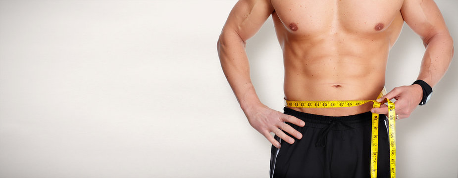 Man Abdomen With Measuring Tape Over Blue Background.