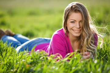 woman are relaxing on the green field 