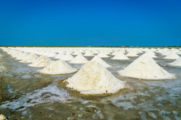 Sea salt fields with piled salt in Thailand