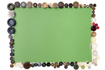 Different buttons arranged around a green piece of paper