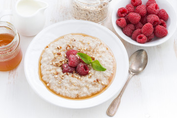 oatmeal with raspberries and honey, top view, close-up