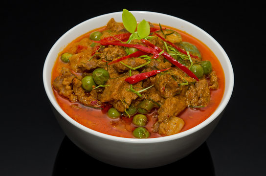 Beef Panaeng, red curry in white bowl black background