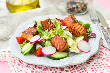 Salad with grilled salmon, radish and cucumber