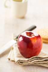 Shining red apple on napkin