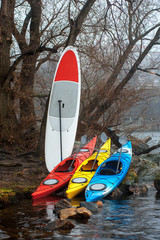 colorful fiberglass kayaks lying on the rocky shore02