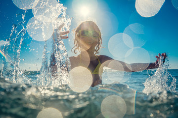 Happy child playing in the sea