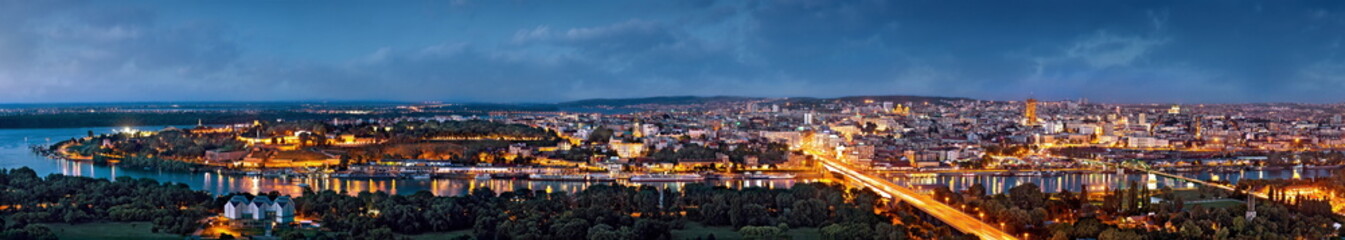 Belgrade panorama by night, Danube and Sava rivers confluence, city lights with blue cloudy sky