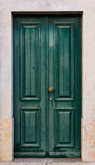 Green door. entrance door in front of residential house.